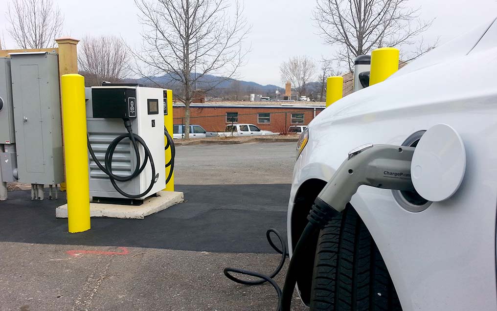 A vehicle plugged into a DC Fast charging station