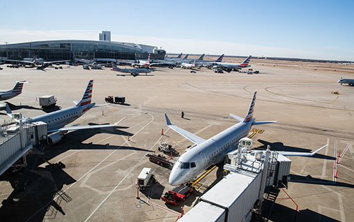 Aircraft getting serviced at airport gates.